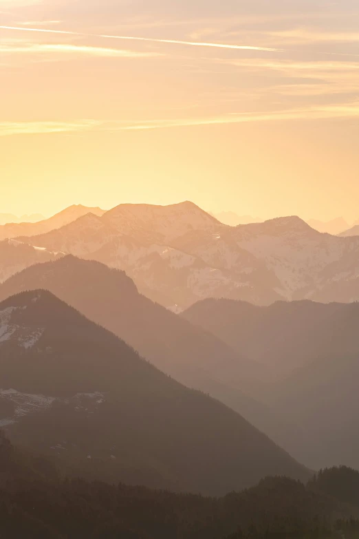 a view of mountains from above a sunset