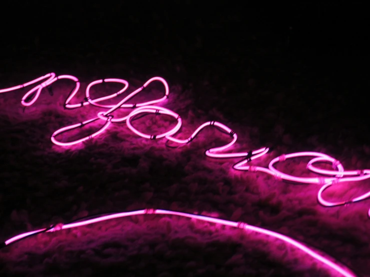 pink neon signs spell out the word love