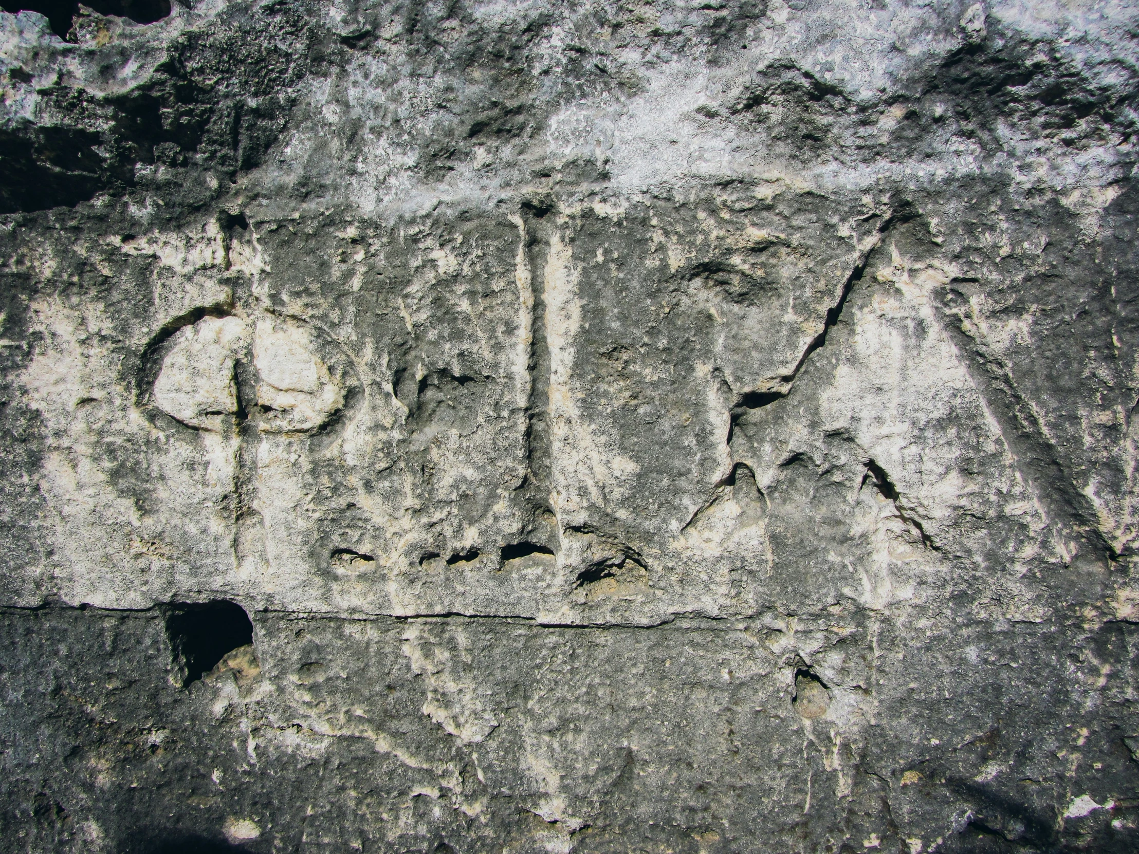 the word aid is written on a large slab of cement