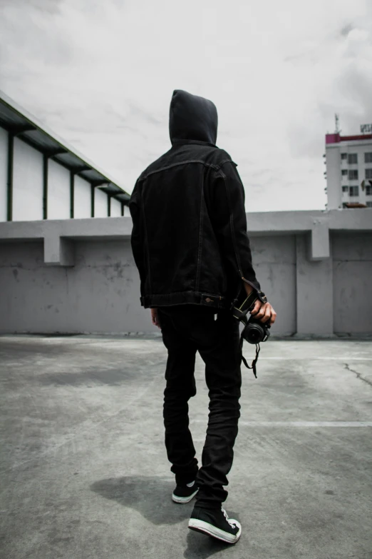 a man is walking toward a concrete building