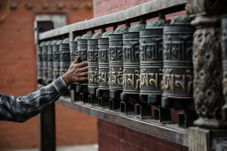 man putting his hands in a bell