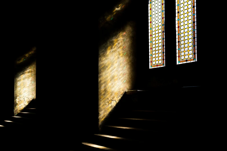 light shining through the window onto a set of stairs