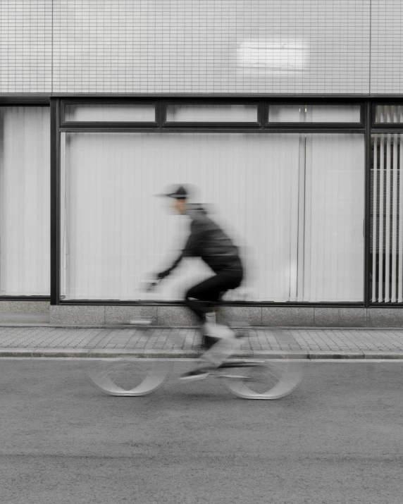 this is a bicycle rider riding down the street