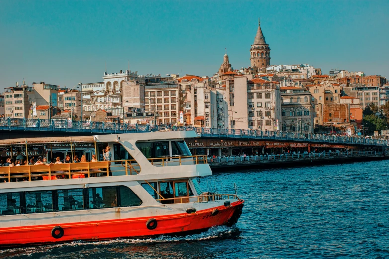 a big boat traveling down the river near some buildings