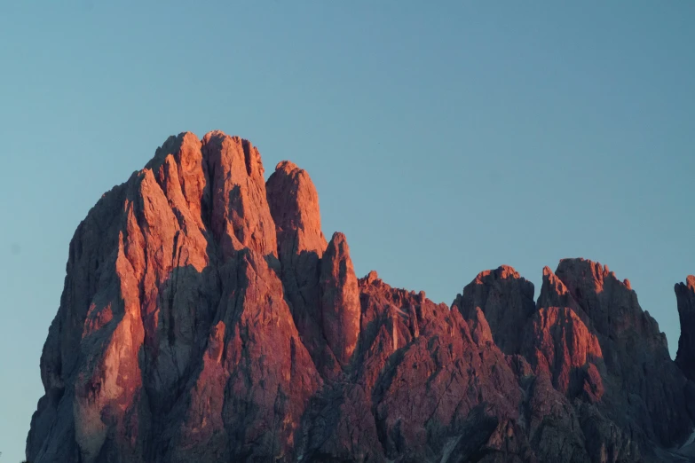 some very tall mountains in the blue sky