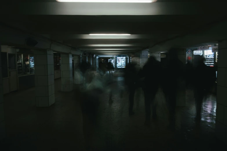 silhouettes of people in an empty building with windows