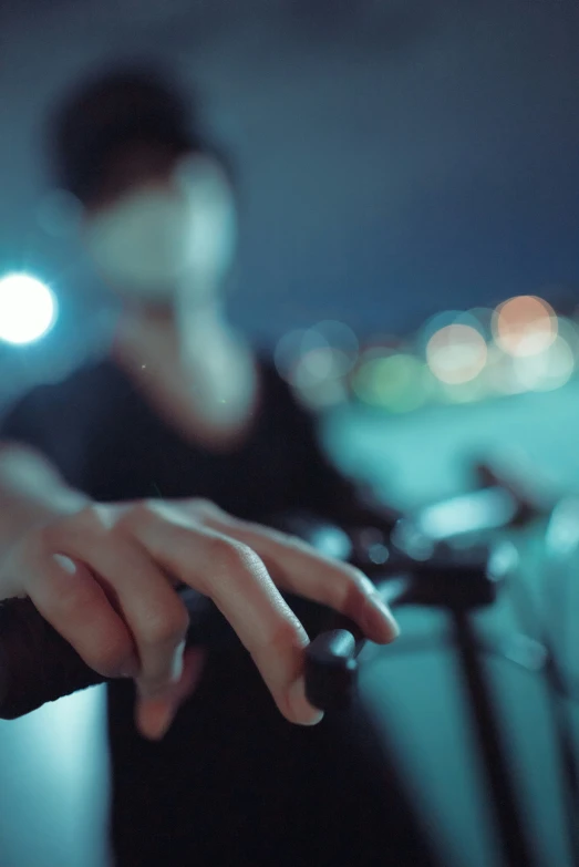 a hand in front of a camera near other people