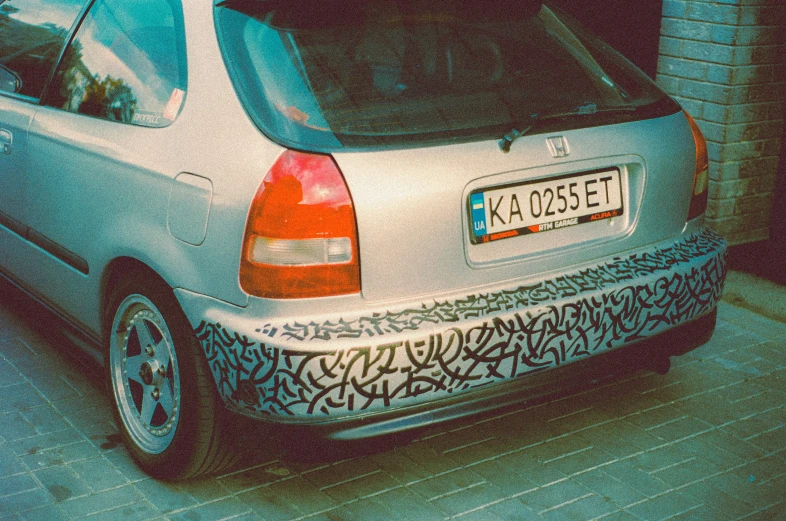 the silver and black car has two white tires