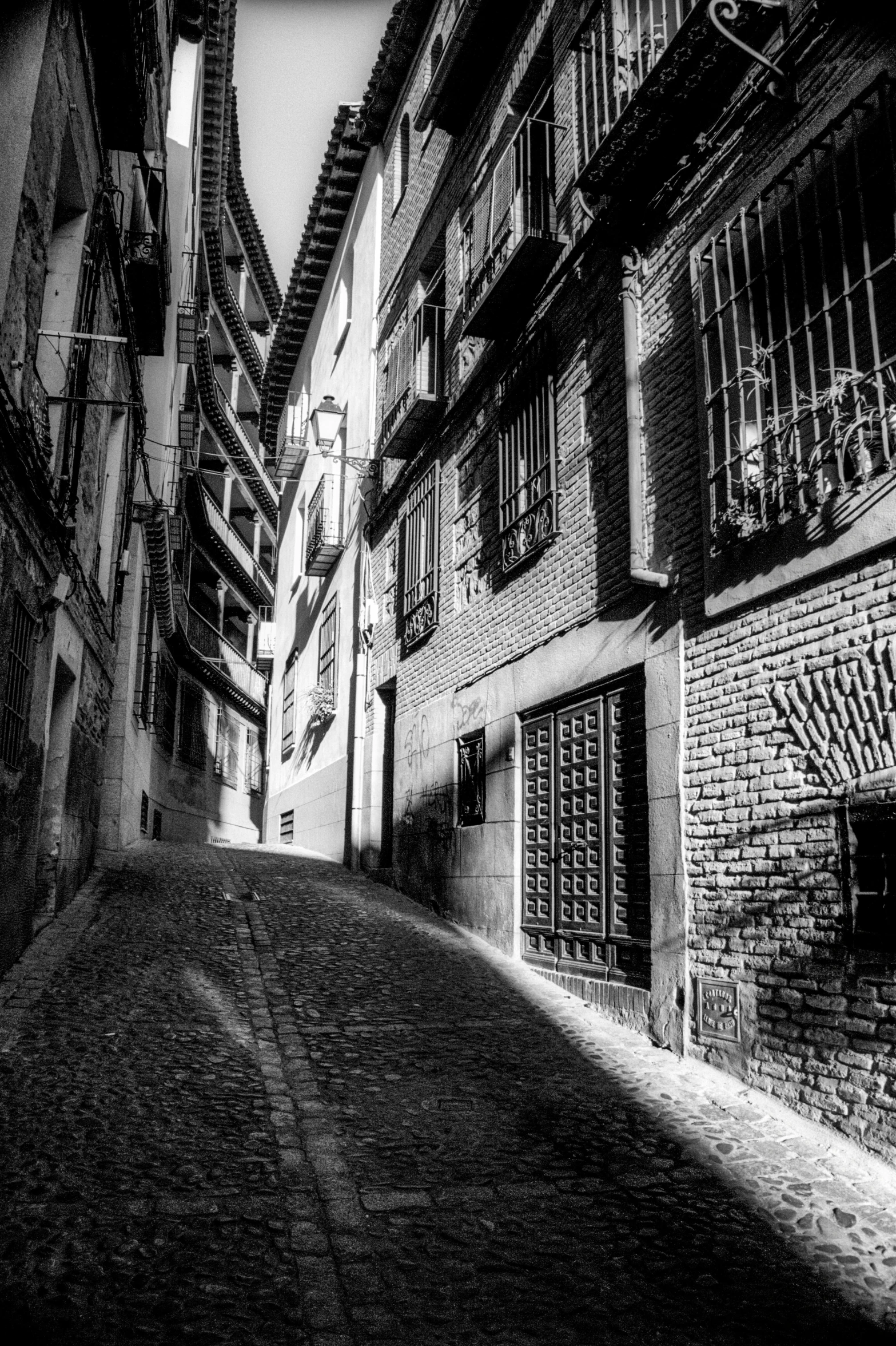 black and white pograph of an alley way in a city
