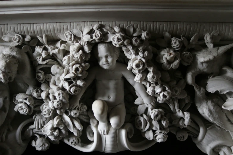 a sculpture of flowers and a boy's head