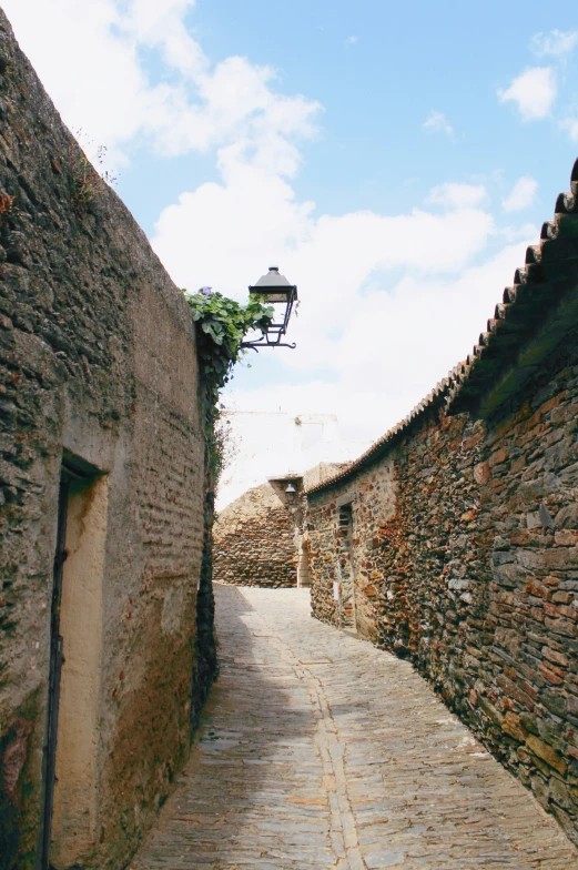 a light is on at an old brick walkway