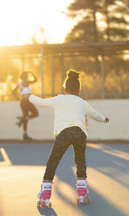 the child is learning to ride on the skateboard