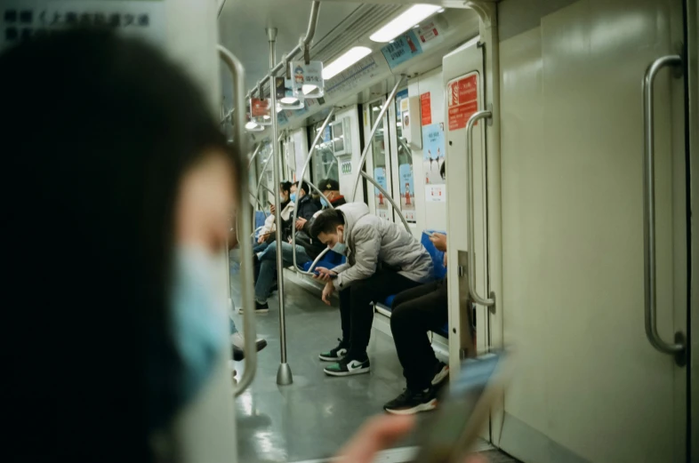 there is a group of people sitting on the subway car