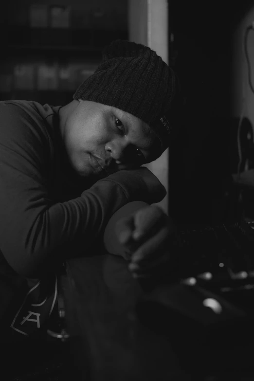 a man with his hand on his face in front of a computer