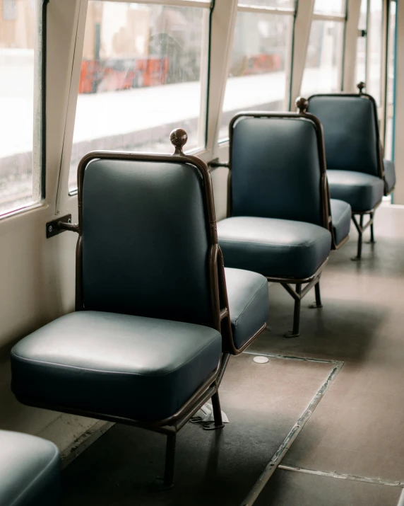 three seats are sitting next to each other on a train