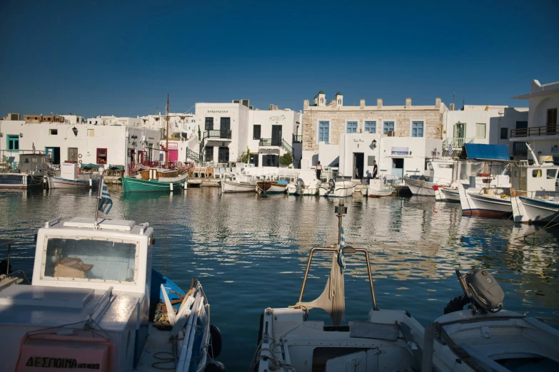 several small boats and buildings in the water