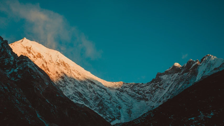 mountains covered in snow in the background with a sky