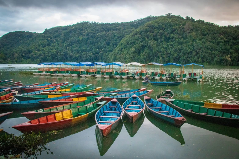 several canoes that are docked next to each other in a lake