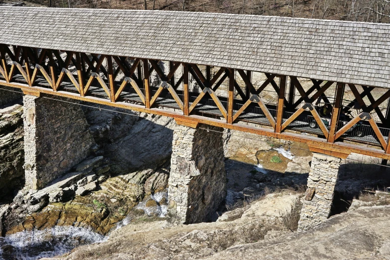 an aerial view of a bridge spanning over a body of water