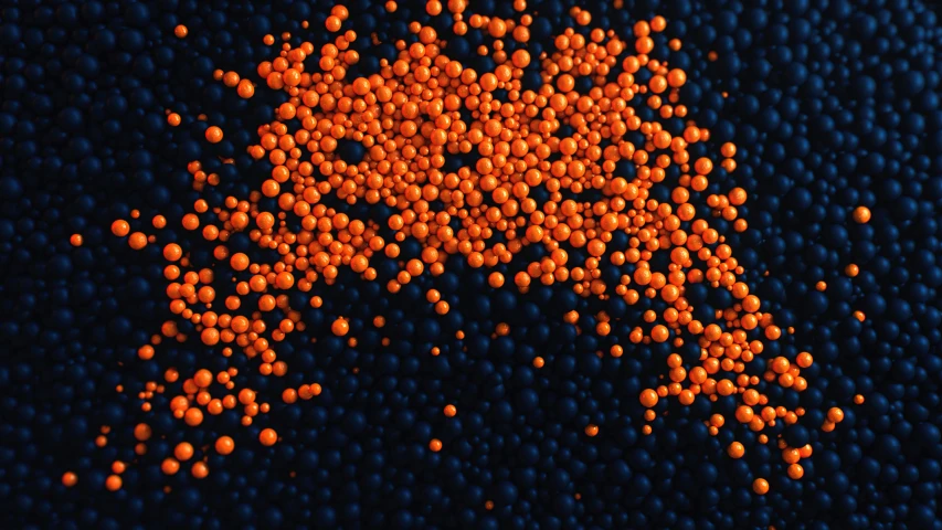 a group of orange balls sitting on top of blue surface