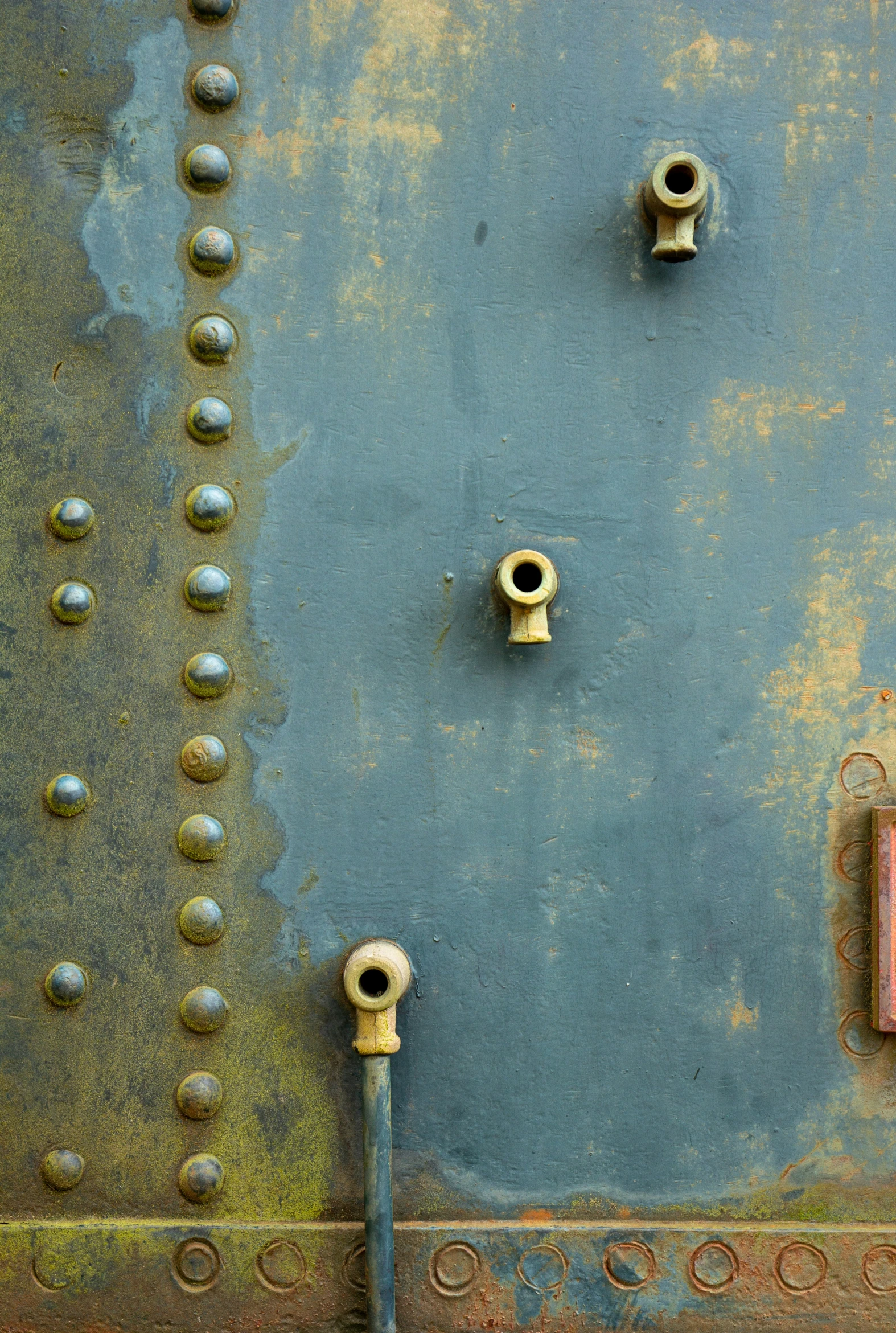 a metal wall with s and a wall switch