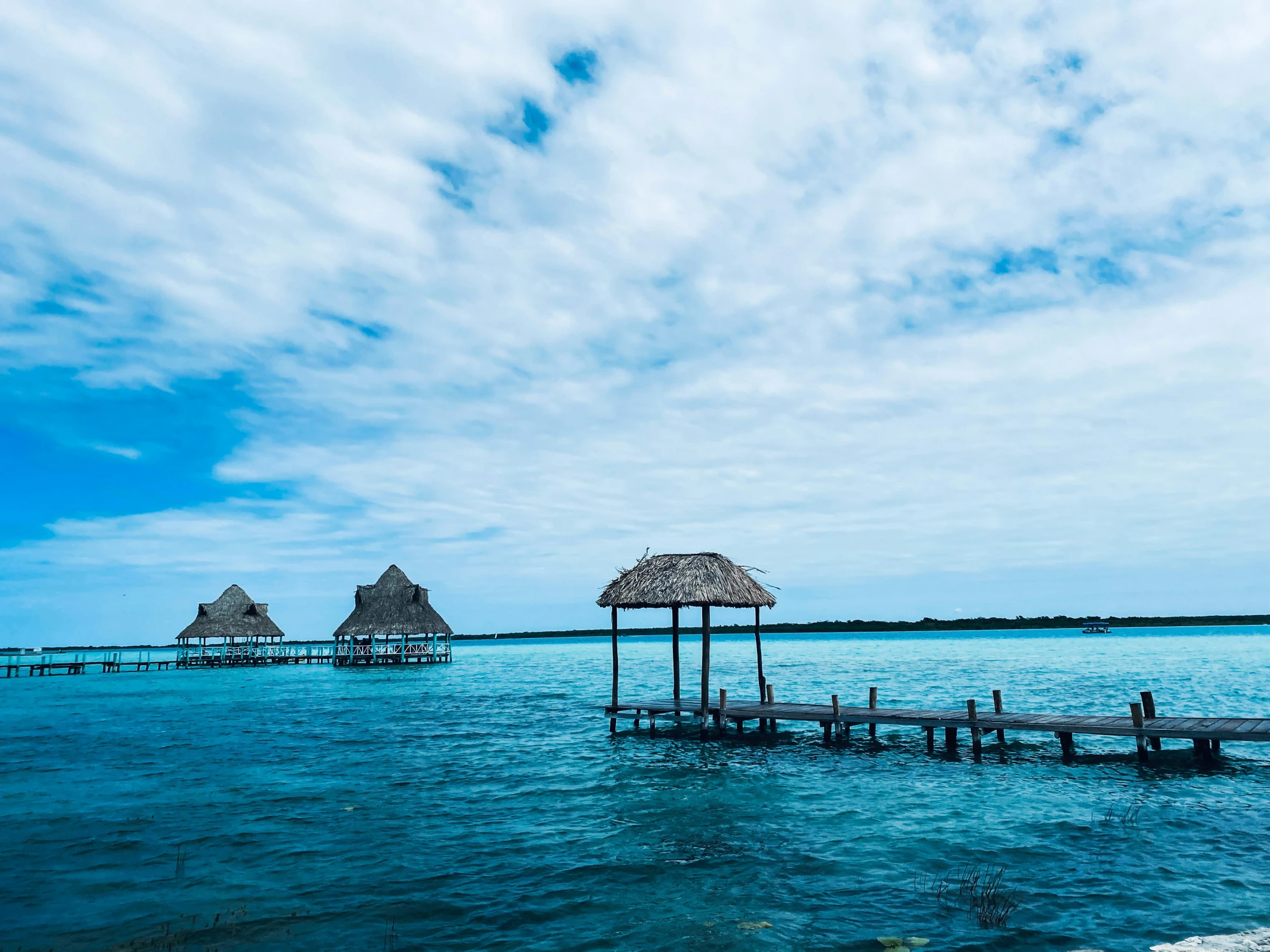 a small hut on stilts that are floating in some water