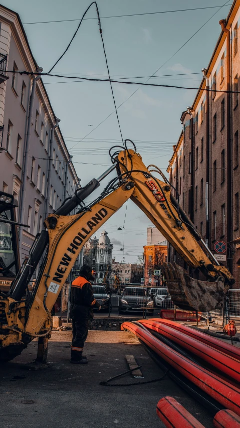 a man that is in a bucket with a construction vehicle