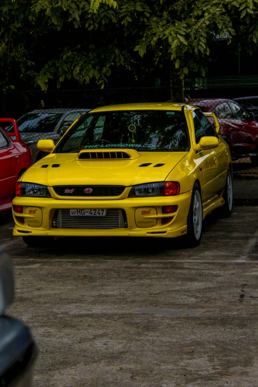 a yellow car parked in a parking lot