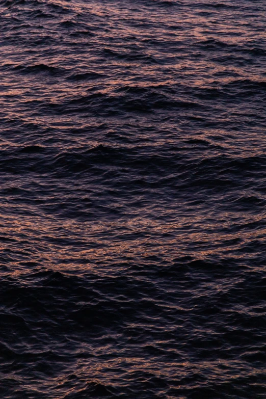 a lone boat is seen in the distance off the water