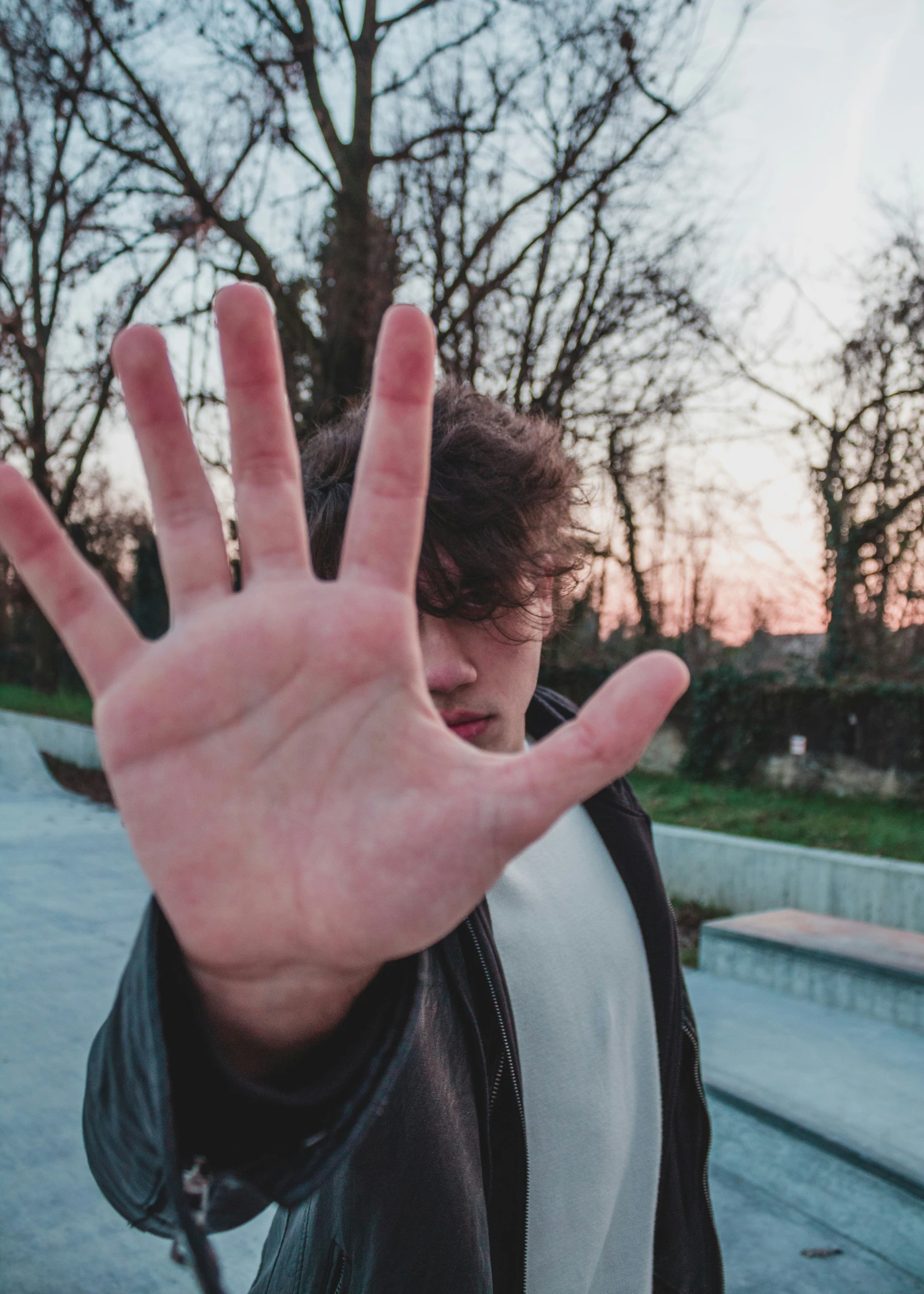 a man making the vulcan sign as he walks outside