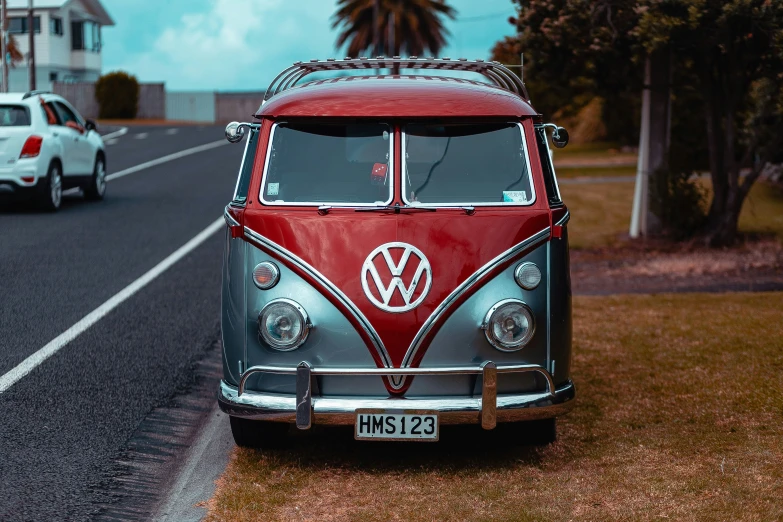 an old vw bus is parked on the side of the road