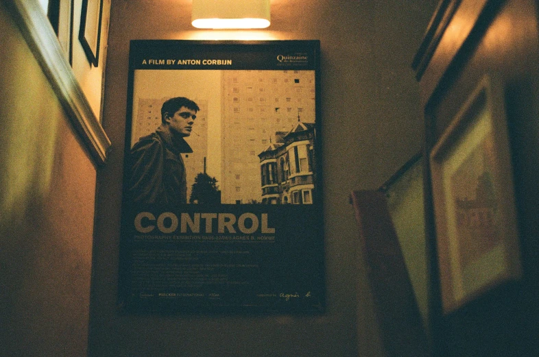 a sign advertising control on a wall in a dark room