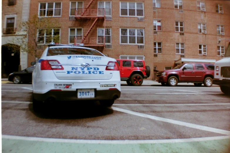 the nypd police cruiser was parked in front of the building