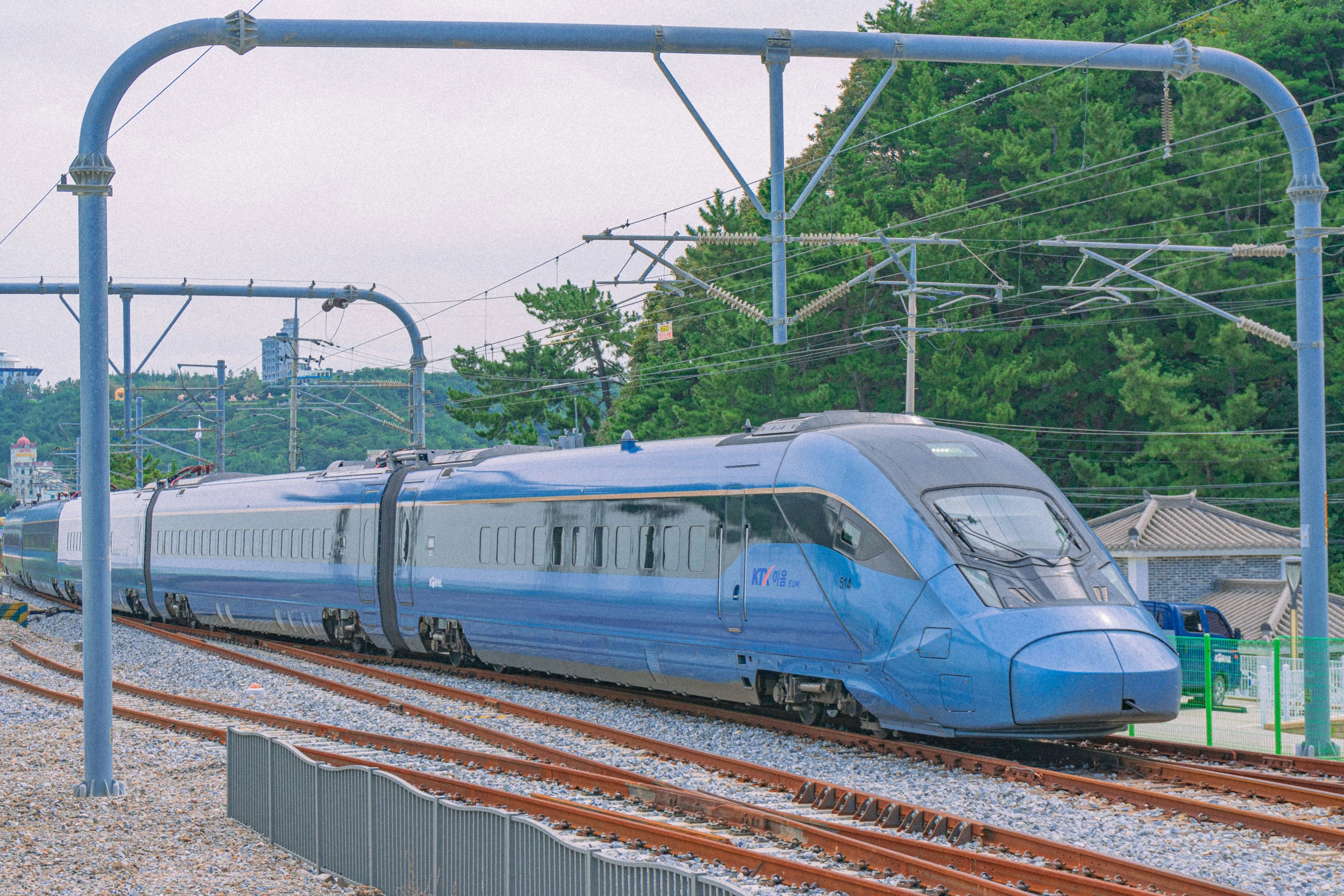 an electric train on the tracks with a man standing beside