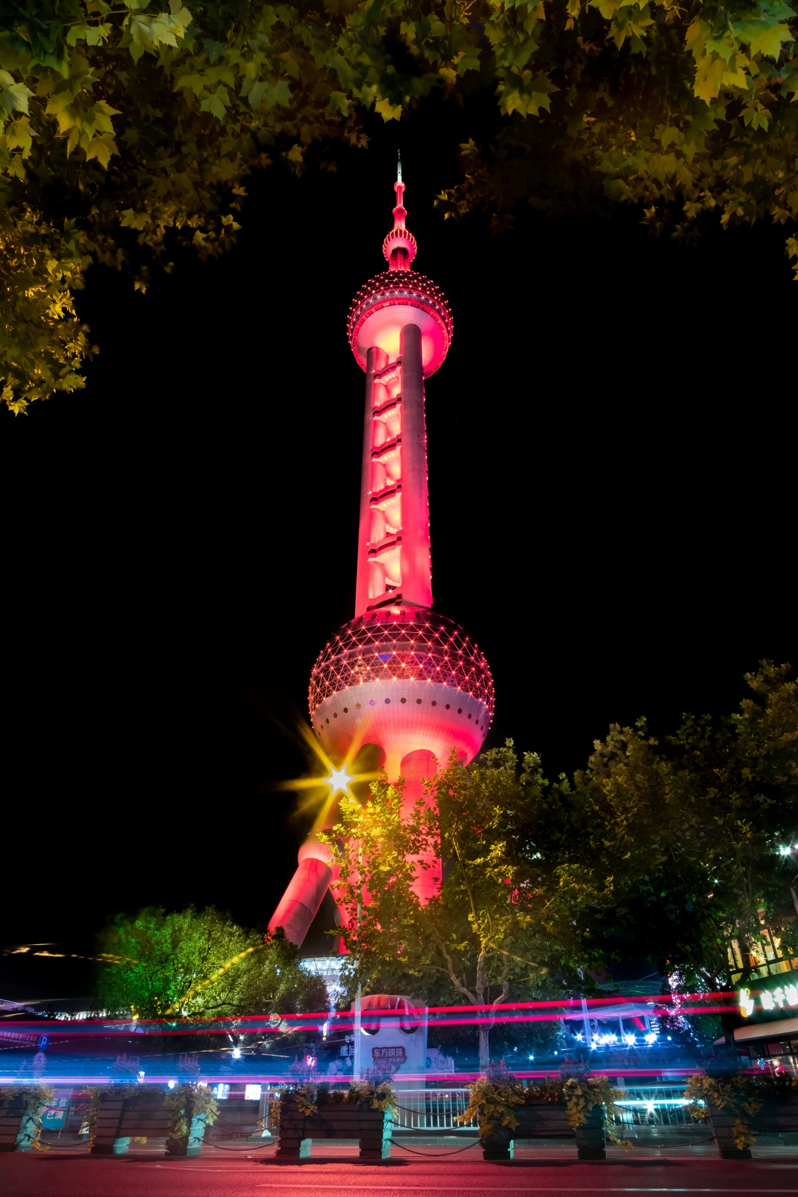 bright lights on a television tower in a nighttime scene