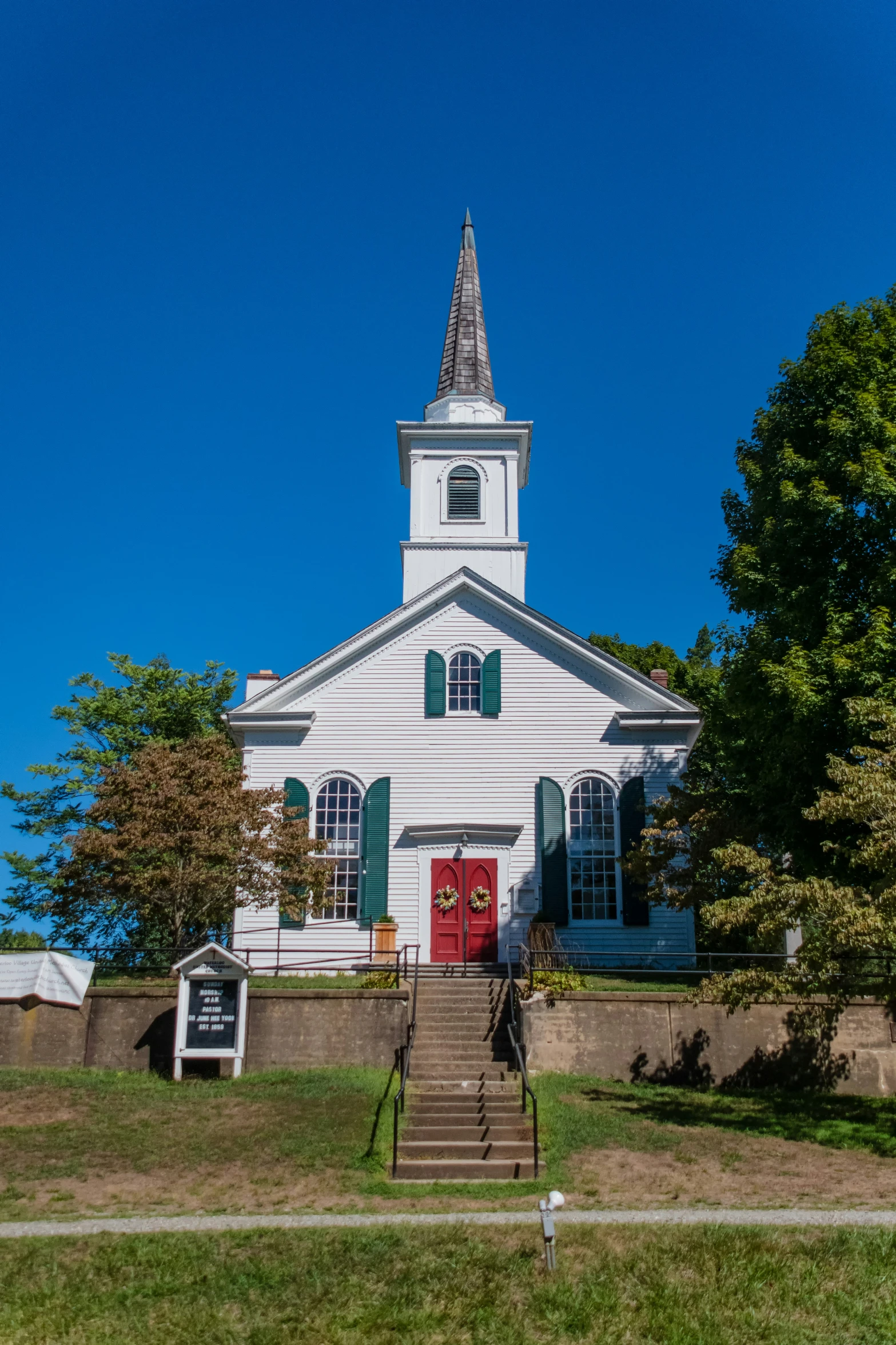 there is a small church with a steeple and doors