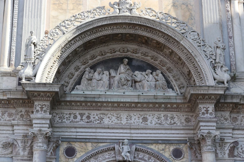 a stone archway has carvings of women on it