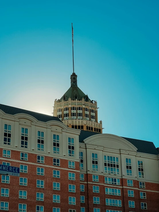 an old building with a flag at the top