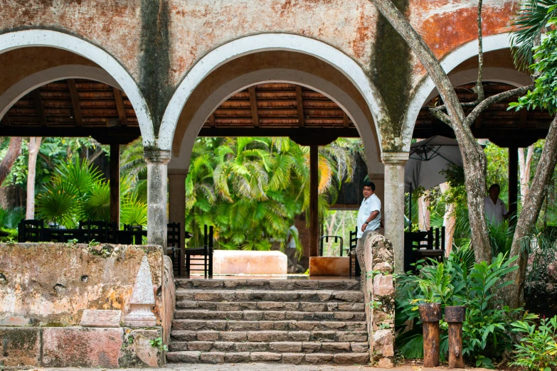 a man sitting on the steps of an outside building