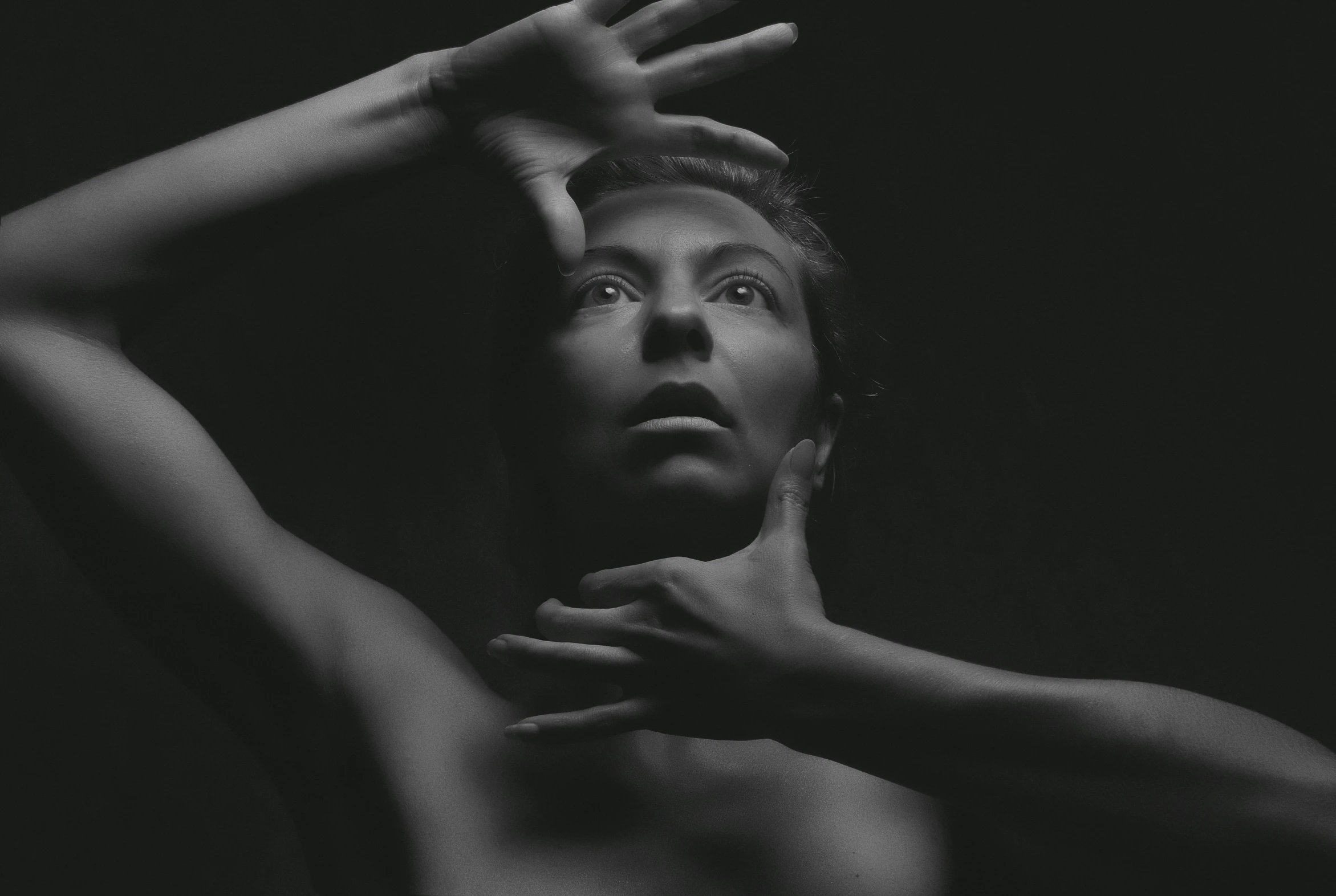 black and white image of woman in a dark pose