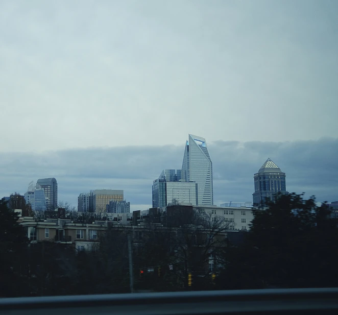 view of the city from behind a window at a freeway