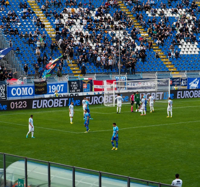 soccer players playing at the stadium with blue and white banners