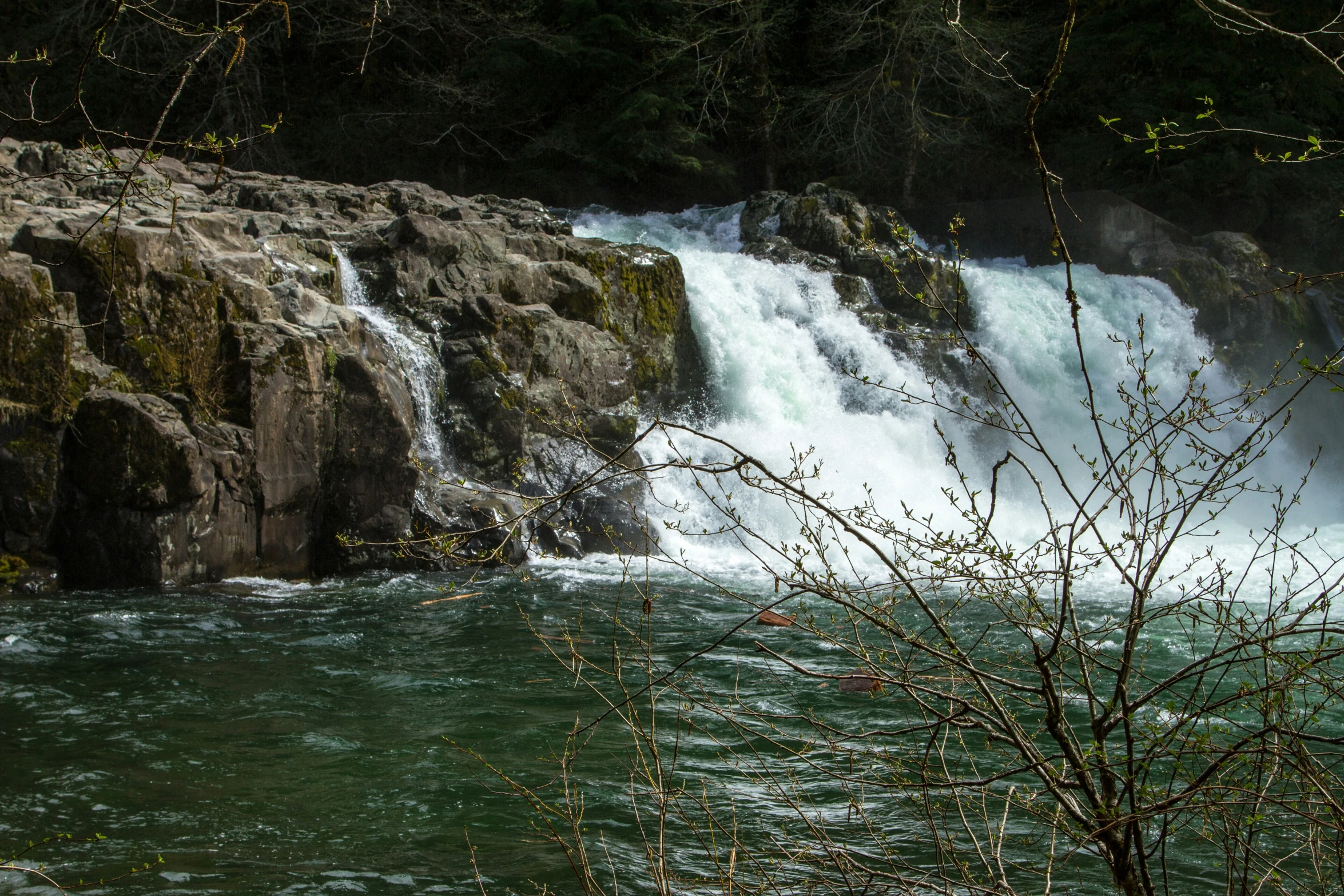 some water a waterfall some trees and water