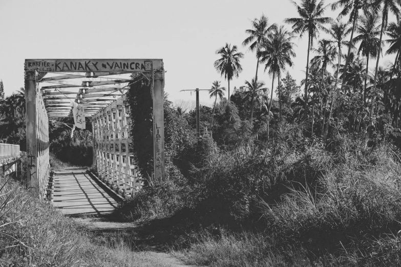 an old rusty looking bridge that is going over water