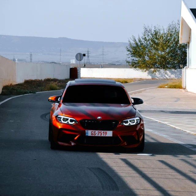 the front end of a red bmw car