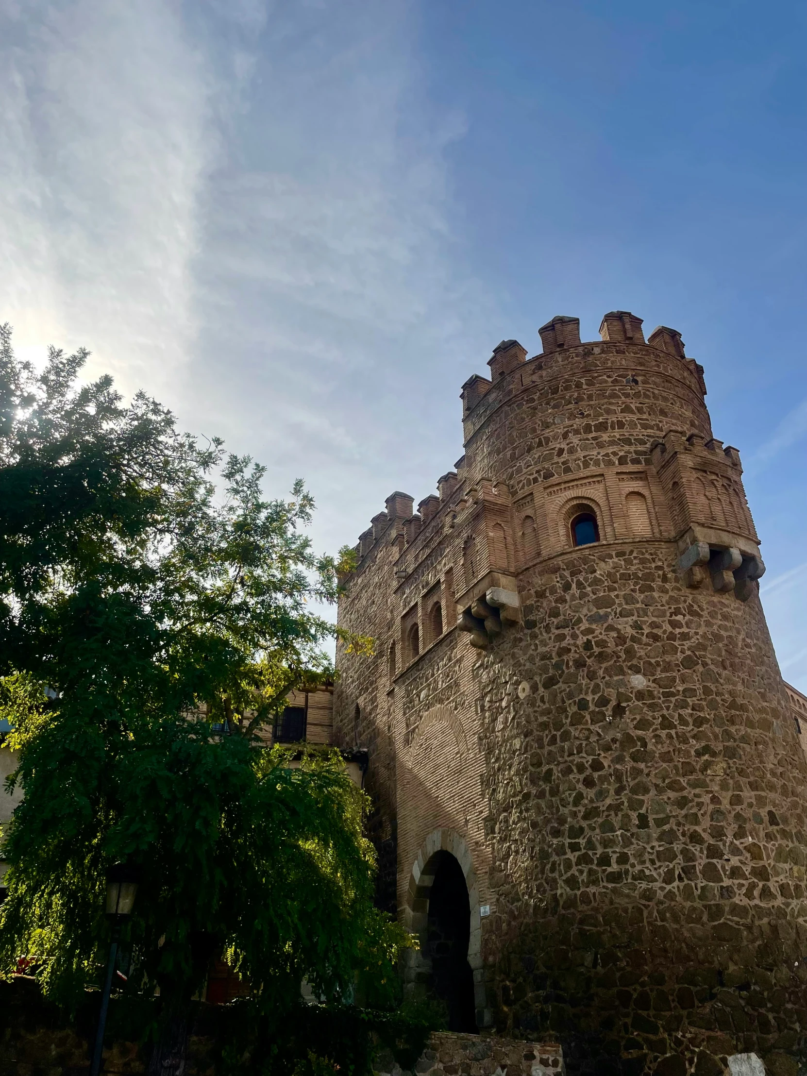 the view from outside of a medieval brick castle