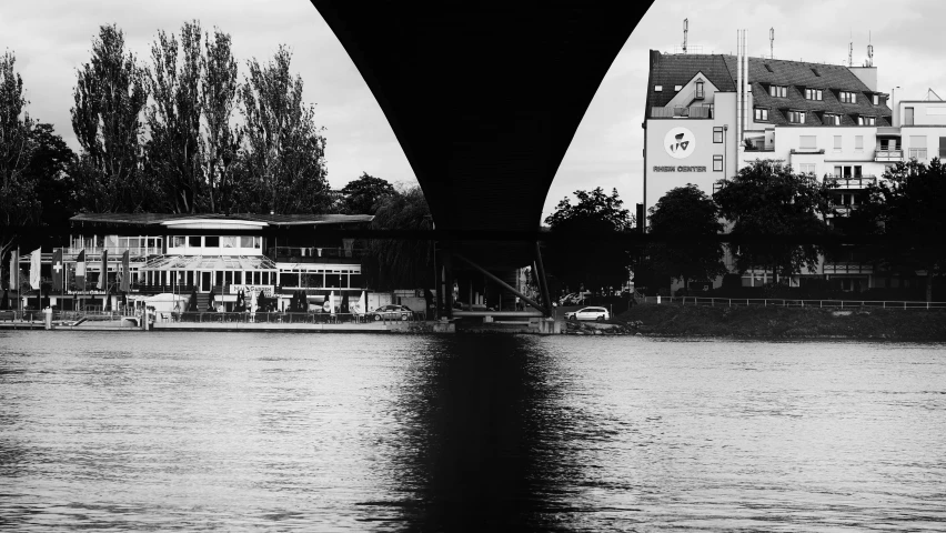 a body of water underneath a bridge next to some houses