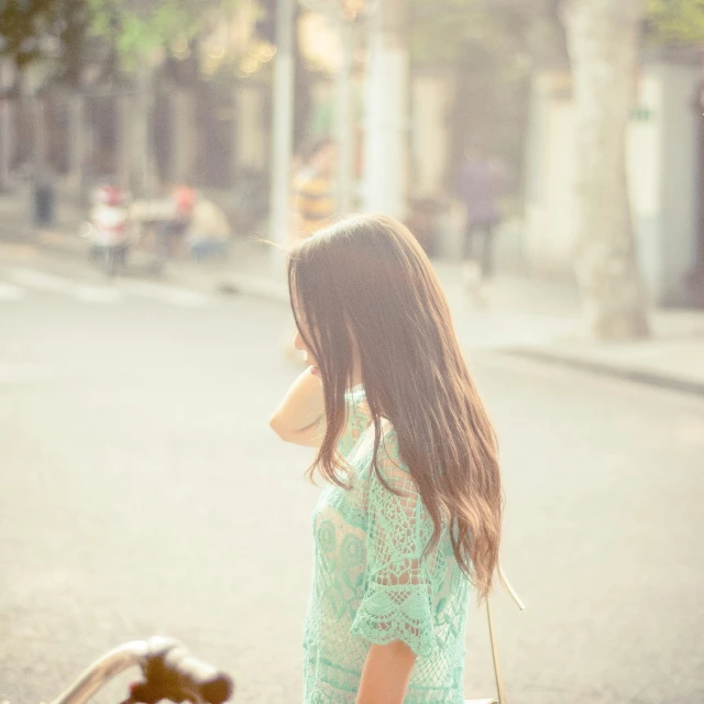 woman with teddy bear looking out over the street