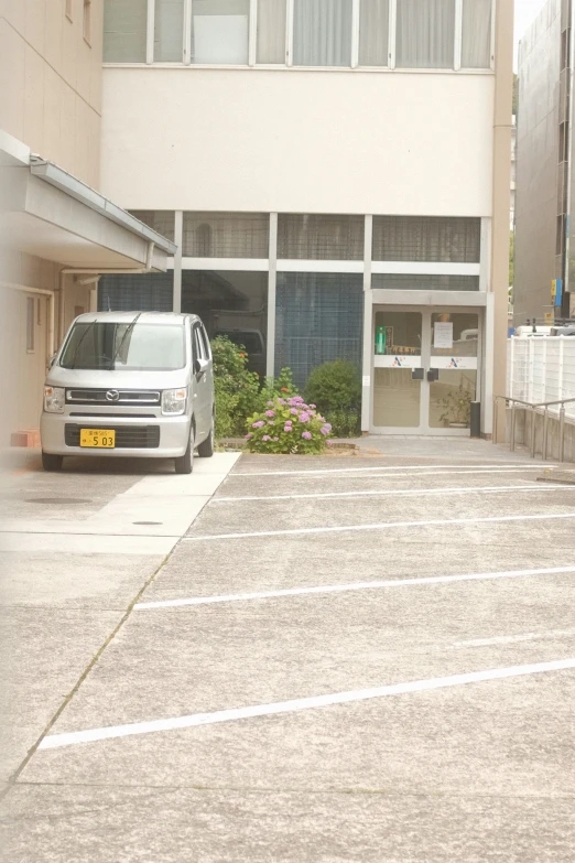 the van is parked at the entrance to the building