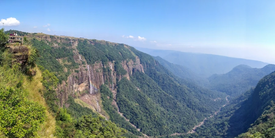 a long mountain slope with a river running through it